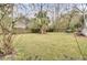 A beautiful grassy backyard featuring mature trees and plenty of space for outdoor activities at 1137 Windsome Pl, Mount Pleasant, SC 29464