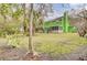 Expansive backyard featuring lush lawn, mature trees, and screened porch, perfect for outdoor living and entertaining at 1137 Windsome Pl, Mount Pleasant, SC 29464