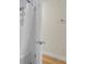 An open bathroom door reveals a shower with white tiled walls and a shower curtain plus a view of the adjacent tan-colored wall at 1137 Windsome Pl, Mount Pleasant, SC 29464