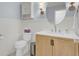 A charming bathroom with wainscoting, a decorative mirror, a sink, and a toilet at 1137 Windsome Pl, Mount Pleasant, SC 29464