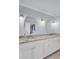 Bathroom showcasing double sinks, white cabinets, granite countertops, and oval mirrors at 1137 Windsome Pl, Mount Pleasant, SC 29464