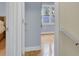 Light-filled bedroom with hardwood floors and a glimpse of a window with trees outside at 1137 Windsome Pl, Mount Pleasant, SC 29464