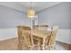 Charming dining room with hardwood floors, soft gray walls, traditional wood table, and a stylish light fixture at 1137 Windsome Pl, Mount Pleasant, SC 29464