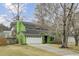 Green two-story home with a well-manicured front lawn, mature trees, and an attached garage at 1137 Windsome Pl, Mount Pleasant, SC 29464