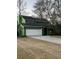 Two-story home featuring a large garage and a spacious driveway nestled under mature trees at 1137 Windsome Pl, Mount Pleasant, SC 29464