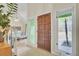 Inviting foyer showcases a wood front door, tiled floors, abundant natural light, and stairway to the upper level at 1137 Windsome Pl, Mount Pleasant, SC 29464