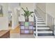 Hallway view featuring staircase with black iron railing, light tile floors, and adjacent doorway at 1137 Windsome Pl, Mount Pleasant, SC 29464