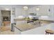 Bright kitchen features stainless steel appliances, stone countertops, tile floors, and views to the living room at 1137 Windsome Pl, Mount Pleasant, SC 29464