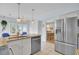 Bright kitchen features stainless steel appliances, stone countertops, tile floors, and an adjacent dining area at 1137 Windsome Pl, Mount Pleasant, SC 29464