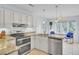 Bright kitchen features stainless steel appliances, stone countertops, and an adjacent dining area at 1137 Windsome Pl, Mount Pleasant, SC 29464