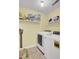 Functional laundry room with washer, dryer, and shelving for ample storage at 1137 Windsome Pl, Mount Pleasant, SC 29464