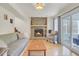 Living room featuring stone fireplace, wood floors, comfortable seating, and access to the screened porch at 1137 Windsome Pl, Mount Pleasant, SC 29464