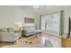 Relaxing living room featuring hardwood floors, comfortable seating, stylish light fixture, and access to the outside views at 1137 Windsome Pl, Mount Pleasant, SC 29464