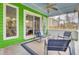 Enjoy this beautiful screened-in porch with comfortable seating, a glass table, and views of the lush backyard at 1137 Windsome Pl, Mount Pleasant, SC 29464