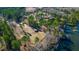Aerial shot of the lake with trees, outbuildings, and a metal shed on a sprawling property at 120 Rancho Hippey Way, Saint George, SC 29477