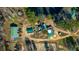 Aerial view of a property with metal buildings, green roofed structures, and plenty of parking at 120 Rancho Hippey Way, Saint George, SC 29477