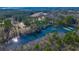 Expansive aerial view showcasing the lakefront property surrounded by lush greenery and mature trees at 120 Rancho Hippey Way, Saint George, SC 29477