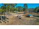 A high angle view of farm buildings, horse paddocks, and horses grazing in a peaceful, rural setting at 120 Rancho Hippey Way, Saint George, SC 29477