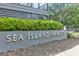 Elegant 'Sea Island Hamlet' sign surrounded by lush greenery, marking the entrance to a beautiful community at 1201 Gatch Ct, Mount Pleasant, SC 29464