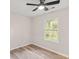 A well-lit bedroom features wood-look floors and a bright window view at 1294 Horseshoe Bnd, Mount Pleasant, SC 29464