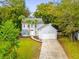 Charming two-story home featuring a well-manicured lawn, mature trees, and attached garage at 1294 Horseshoe Bnd, Mount Pleasant, SC 29464