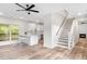 Bright open-concept living area with hardwood floors, stairs, and a modern fireplace at 1294 Horseshoe Bnd, Mount Pleasant, SC 29464