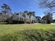 Charming two-story home with a welcoming front porch, mature trees, and beautifully manicured lawn at 130 Marshside Dr, Summerville, SC 29485