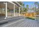 Wide view of the screened-in porch, featuring a ceiling fan and white railings at 130 Marshside Dr, Summerville, SC 29485