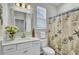 Bright bathroom with a white vanity and seashell themed shower curtain at 138 O'Malley Dr, Summerville, SC 29483