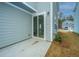 Backyard features a patio with sliding glass doors, neat landscaping, and blue siding at 143 Brant Dr, Summerville, SC 29483