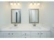 Bathroom vanity featuring double sinks, granite counters, chrome faucets, and decorative mirrors at 143 Brant Dr, Summerville, SC 29483