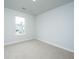 Bright bedroom featuring neutral carpet, a double-hung window, and white trim at 143 Brant Dr, Summerville, SC 29483