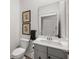 Powder room featuring a gray vanity, white toilet, and framed artwork at 1510 Martel St, Mount Pleasant, SC 29464