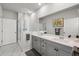 Modern bathroom featuring a double sink vanity, glass-enclosed shower, and neutral color palette at 1510 Martel St, Mount Pleasant, SC 29464