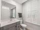 Stylish bathroom with a vanity, toilet, mirror and plantation shutters on the window at 1510 Martel St, Mount Pleasant, SC 29464