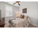 Cozy bedroom with a patterned duvet cover, side table with lamp and plantation shutters at 1510 Martel St, Mount Pleasant, SC 29464