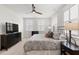 Bedroom with a bed, dark wood furnishings, neutral carpet, television, and abundant natural light at 1510 Martel St, Mount Pleasant, SC 29464