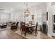 Open concept living and dining area with wood floors and modern decor, adjacent to the living room at 1510 Martel St, Mount Pleasant, SC 29464
