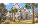Attractive row of brick townhomes with palm trees, sidewalks and manicured landscaping at 1510 Martel St, Mount Pleasant, SC 29464