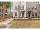Charming townhomes featuring brick facade, modern awnings, and well-maintained landscaping for a welcoming curb appeal at 1510 Martel St, Mount Pleasant, SC 29464