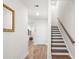 Bright foyer featuring hardwood floors, white walls, stairs and accent mirror at 1510 Martel St, Mount Pleasant, SC 29464