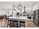 Modern kitchen with white cabinets, stainless steel appliances, quartz countertops and island with seating at 1510 Martel St, Mount Pleasant, SC 29464