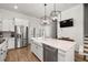 Stylish kitchen featuring white cabinets, island with seating, stainless steel appliances, and gas range at 1510 Martel St, Mount Pleasant, SC 29464