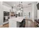 Bright kitchen featuring white cabinets, quartz countertop island, pendant lighting, and French doors at 1510 Martel St, Mount Pleasant, SC 29464