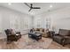 Cozy living room with hardwood floors, neutral walls, plantation shutters, ceiling fan and comfortable seating at 1510 Martel St, Mount Pleasant, SC 29464