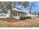 Backyard featuring a screened in porch and a large tree at 1545 Sterling Oaks Dr, Moncks Corner, SC 29461