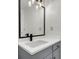 Stylish bathroom featuring a vanity with matte black faucet and large mirror with modern lighting at 1545 Sterling Oaks Dr, Moncks Corner, SC 29461