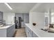 Charming kitchen features gray cabinets, stainless steel appliances, and a large island with quartz countertops at 1545 Sterling Oaks Dr, Moncks Corner, SC 29461