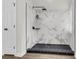 Contemporary shower with stylish black fixtures and marble-patterned tile at 1545 Sterling Oaks Dr, Moncks Corner, SC 29461