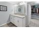 Bright bathroom featuring double vanity with granite countertops, leading to an organized walk-in closet at 1559 Innkeeper Ln, Johns Island, SC 29455